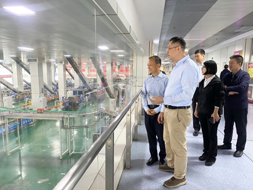 驻武汉办主任郭伟勋(左二)在山西省人民政府港澳事务办公室副主任郝文杰(右二) 及吕梁市人民政府台港澳事务办公室主任高侯平(右一)陪同下，参观汾阳市一家龙头企业的生产车间。